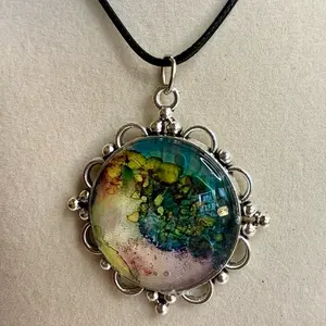 Colorful necklace hand painted with alcohol inks on a 20” black leather cord.