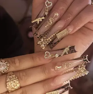 bow-shaped golden rhinestone press-on nails with leopard print, long length.