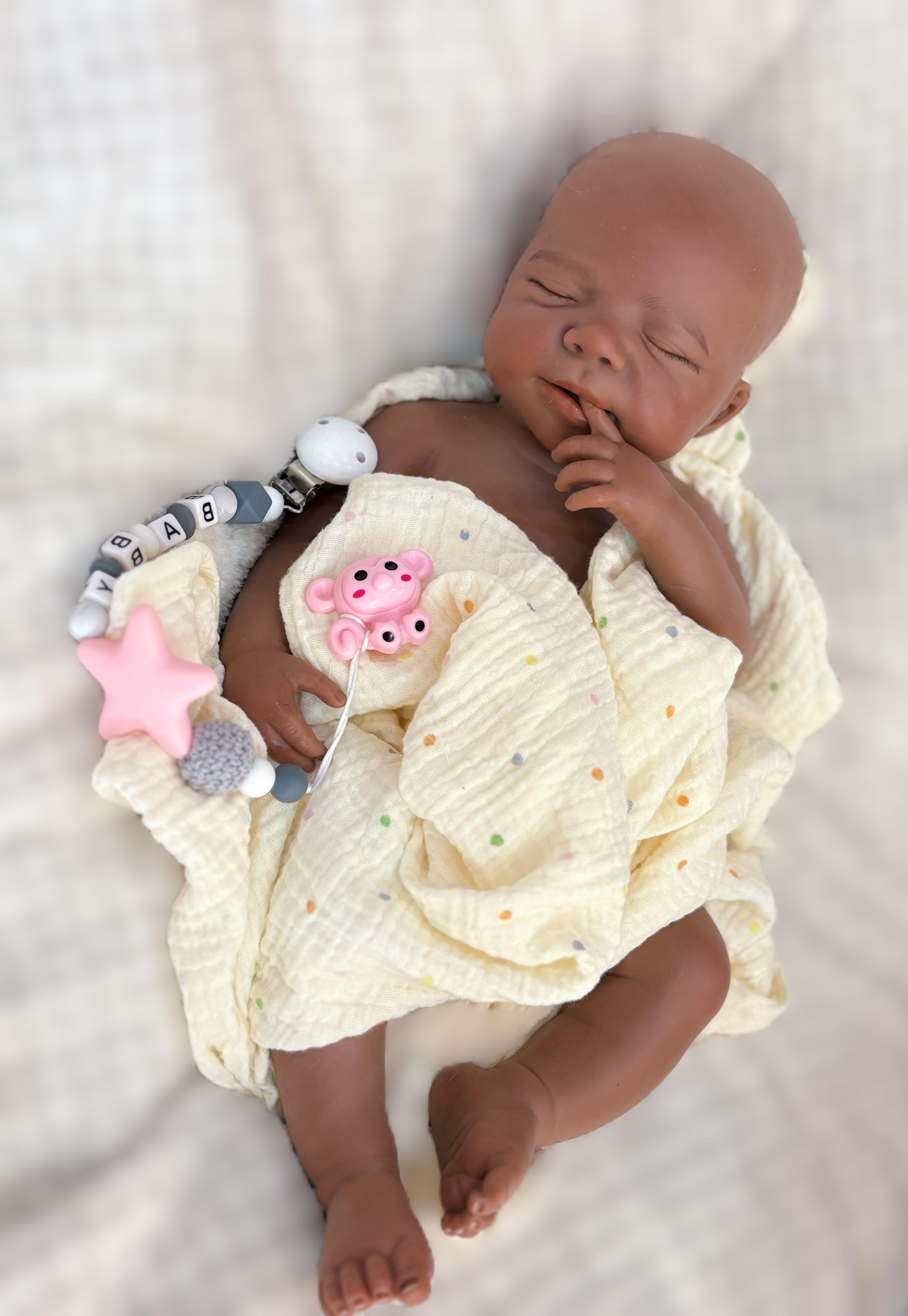 Reborn doll, soft silicone — 18 inches tall, lifelike with closed eyes for sleeping, brown skin, a soft body, and realistic detailed features. Includes a comfort item, a bottle, and a birth certificate. Perfect for birthday gifts, collectors, and children