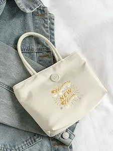 Elegant Cream Handbag with Short Rounded Handles - Structured Rectangular Design Featuring 'Happy New Year' Gold Foil Graphic and Metallic Emblem, Perfect for Chic Holiday Events and Everyday Use