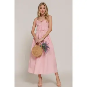 Long dress with front bow detail and ruffles.