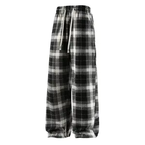 A pair of men's plaid drawstring pants, featuring a casual retro style, convenient adjustable drawstring waistband, soft and skin friendly fabric, loose and comfortable fit, suitable for men who enjoy a casual retro look for everyday outings, coffee shop