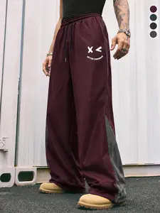 Men’s color-block smiley print athletic pants, high-street functional style + casual sporty vibe, elastic waistband fabric, burgundy/black/gray available, Y2K retro smiley print wide-leg pants, dark casual style