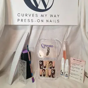 Introducing the new CMW Press-On Nails—a bold statement of elegance. These nails feature a rich chocolate brown paired with soft beige, adorned with 3D floral designs, delicate polka dots, and gold stud accents. Exclusively in size large,