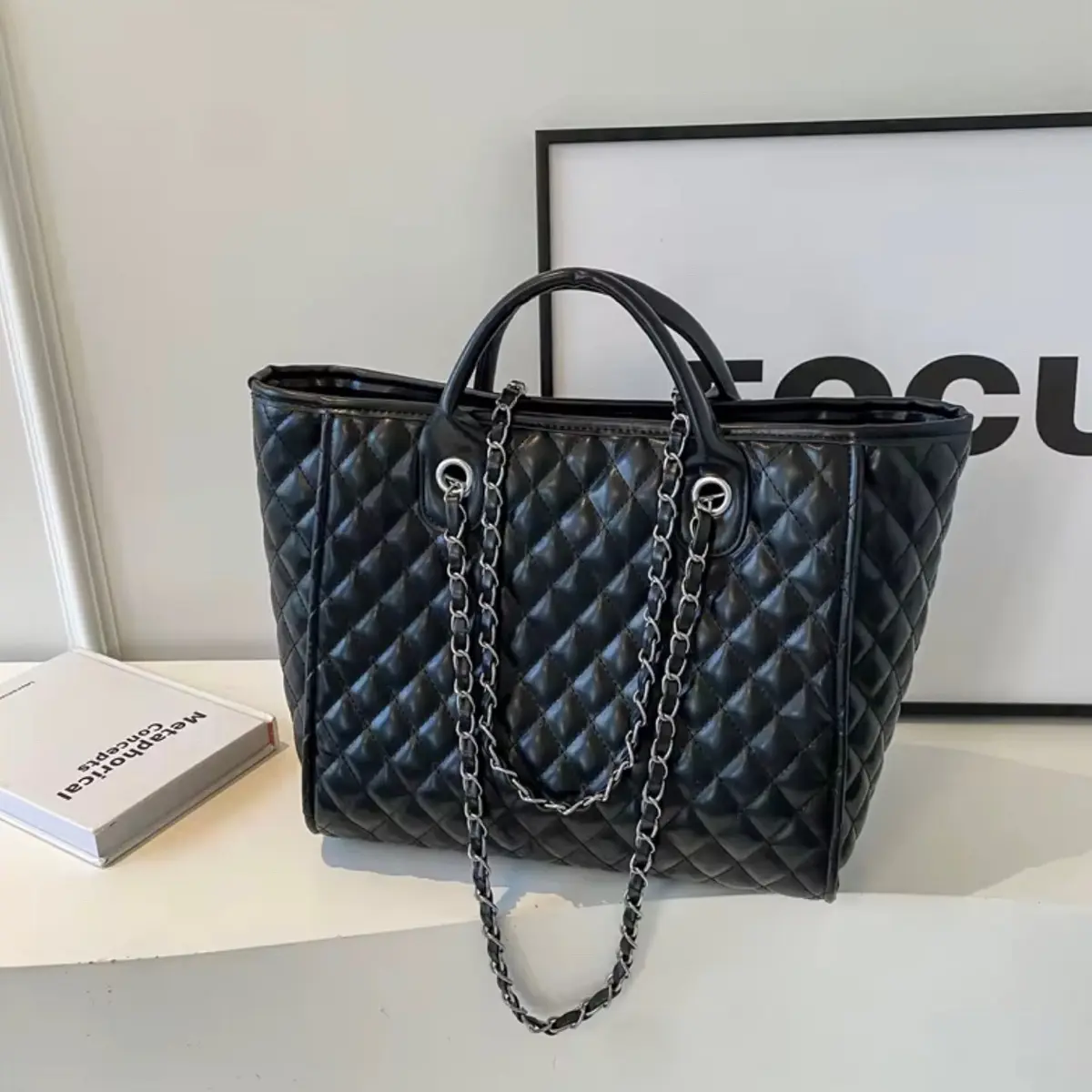 Barrel Aura Bag - Black Leather Handbag with Chain Strap, Quilted Design, and Adjustable Handles