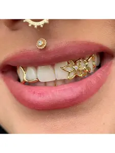 Personalized fashionable dental braces with flower-shaped hollow design and two gold teeth. Cool Halloween dental accessory.