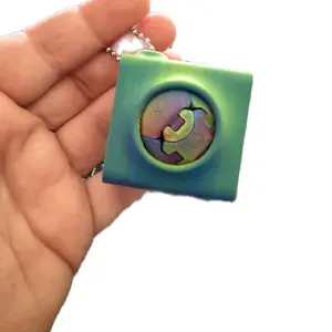 Zorbles round ball designer fingerine in carrier   Creator  is : Blob Labs