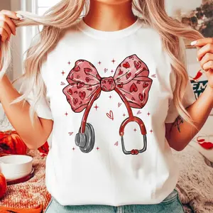 Valentine Nurse T-Shirt for Women, Cute Pink Bow Stethoscope Heart Graphic Tee, Coquette Medical Shirt, Valentine’s Day Nurse Gift for Nurses, RN, LPN, Nursing Students, Healthcare Workers