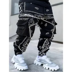 Men’s multi-pocket work pants with a cashew flower print and glow print, featuring zippered pockets; casual running/graffiti streetwear pants shipped from the U.S.; black menswear graffiti pants for warehouse wear.