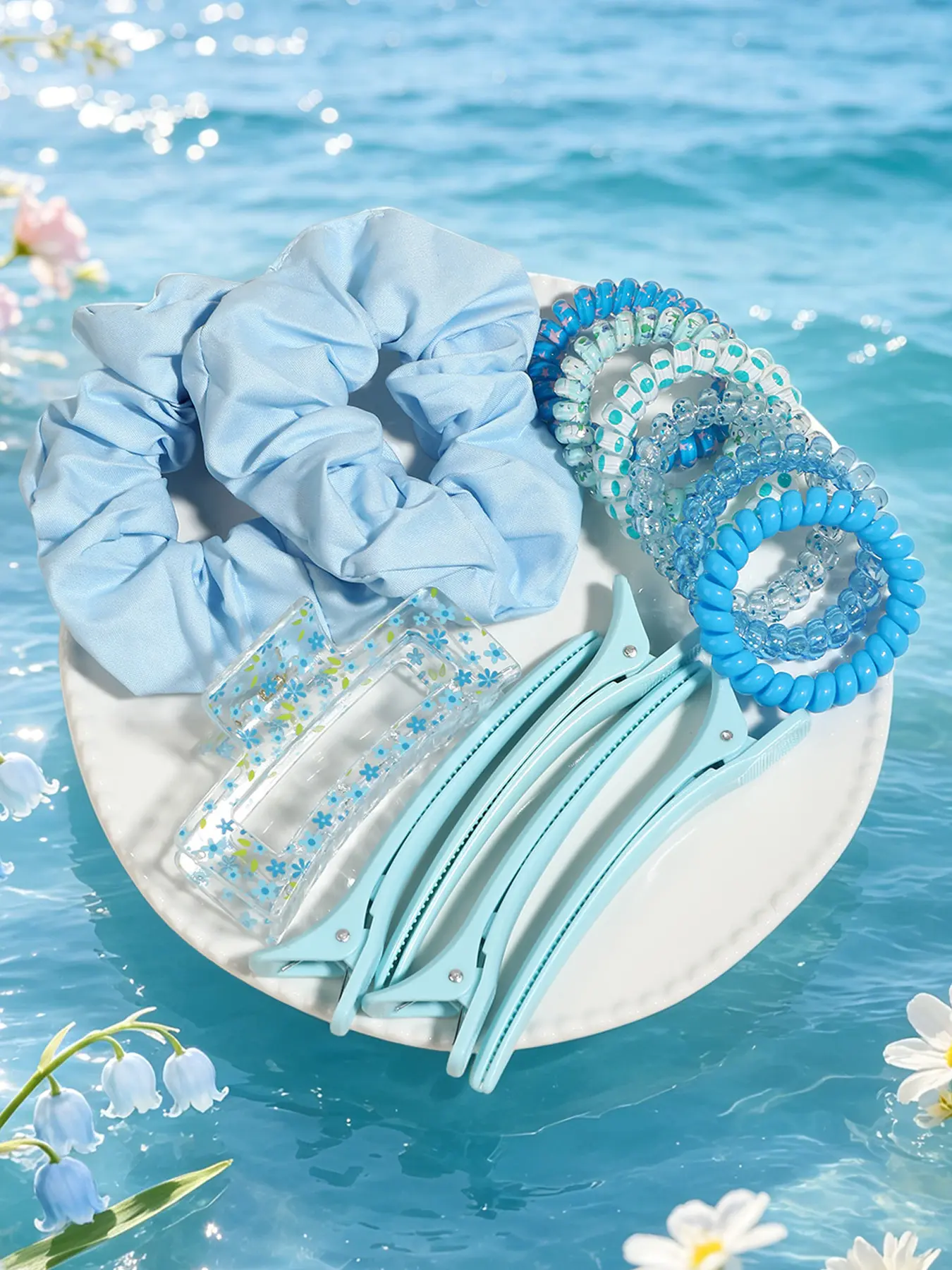 Seaside hair accessory set in sea salt blue bellflower style! Satin scrunchie, spiral hair tie, floral hair claw and duckbill clip. It gives a fresh and fair skin tone look with a cooling vibe, perfect for stunning travel photos.