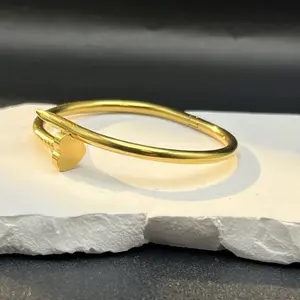 Gold-Tone Bangle Bracelet with Sleek Design and Secure Clasp for Everyday Wear