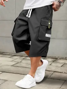 Men’s summer casual cargo shorts — elastic drawstring waist, multiple pockets and letter appliqué design; regular fit with a mid rise that doesn’t stretch; non see through fabric for everyday wear and leisure activities.