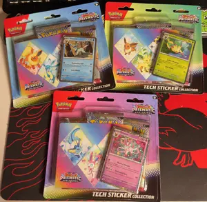 Pokémon Prismatic Evolutions Tech Sticker Collection Set of 3 Includes Foil Promo Card Tech Sticker Sheet and 3 Booster Packs from Scarlet & Violet Expansion