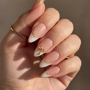 24 white pointed nail tips, medium almond shape gradient nail art, Y2K style, gold 3D bowknot glitter with irregular line decoration, glossy and colorful detachable design, novel and fashionable full coverage, suitable for ladies' daily wear