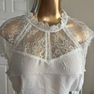 Elegant White Blusa with Intricate Lace Detailing and High Neck Design for a Timeless Look