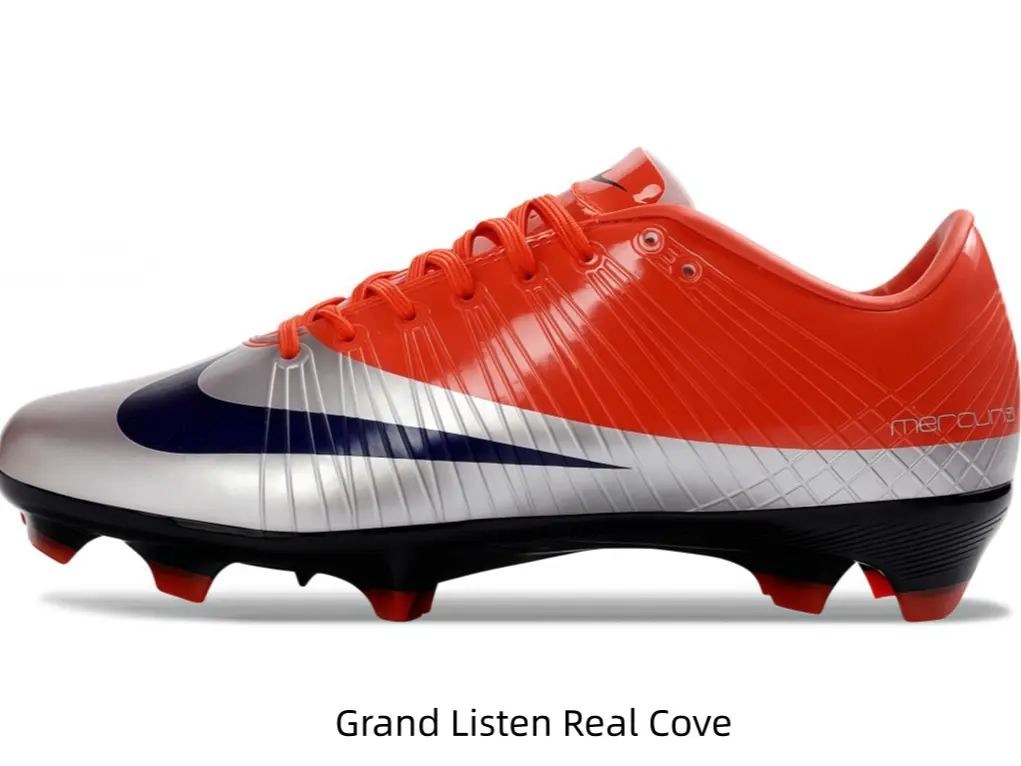 Vibrant orange silver gradient soccer cleats with dark navy graphic and red traction studs
