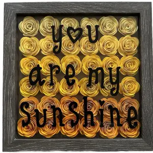 Shadow box with rolled paper flowers.