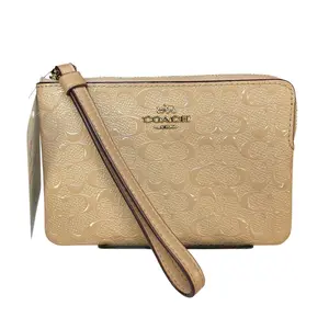 Pre-owned coach Patent Leather Clutches & Wristlets Nude Patent Signature C Wristlet Gold Hardware Zip Pouch Beige Wallet Clutch