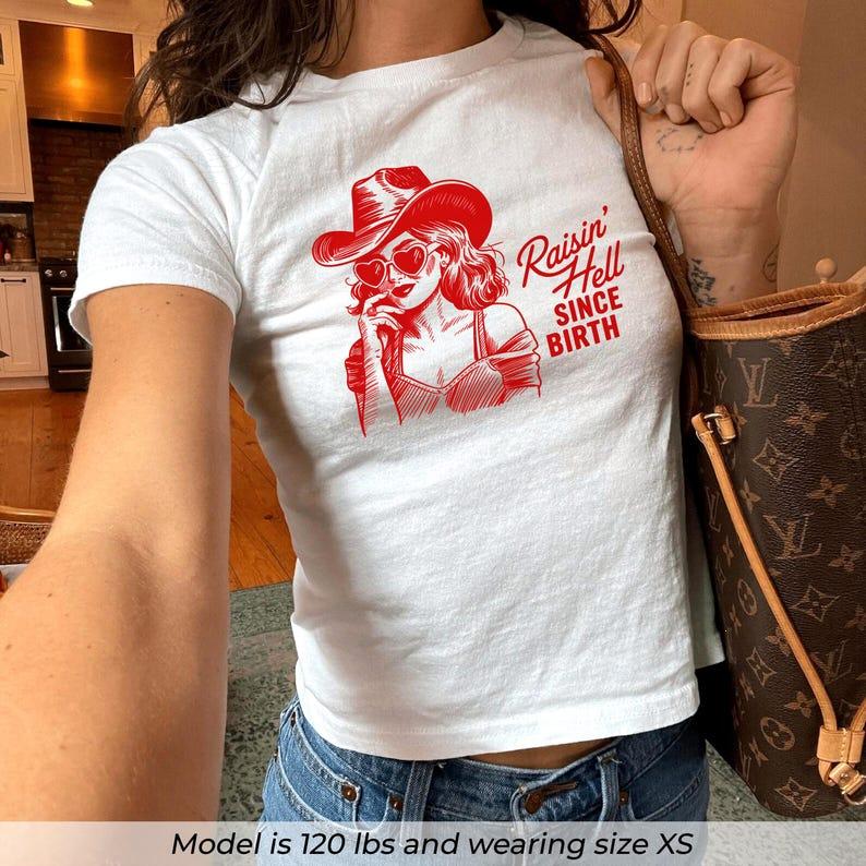 Raisin Hell Baby Tee, Western Cowgirl Baby Tee, Nashville Girls Trip Tee, Y2K Country Graphic Shirt, Strong Woman Crop Top, Baby Tee Women