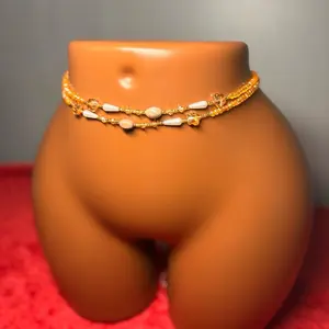 Auntie Ama's Celestial Glow Crystal Waist Beads - Orange & White Bead Design on Orange Mannequin Display