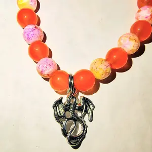Peach Dragon Charm Bracelet with Colorful Beads and Unique Dragon Pendant Design