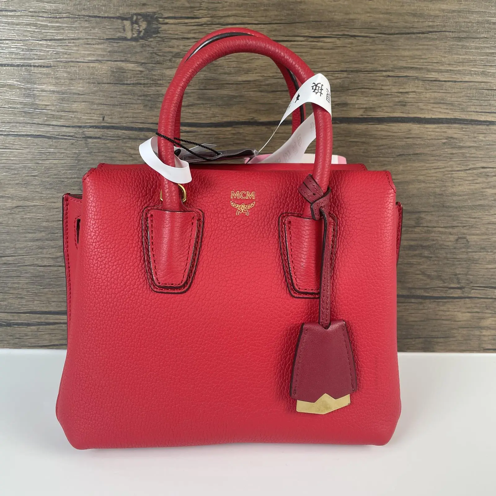 Pre-owned MCM Leather Crossbody Bags Red Grained Mini Top Handle Satchel Handbag with bag charm