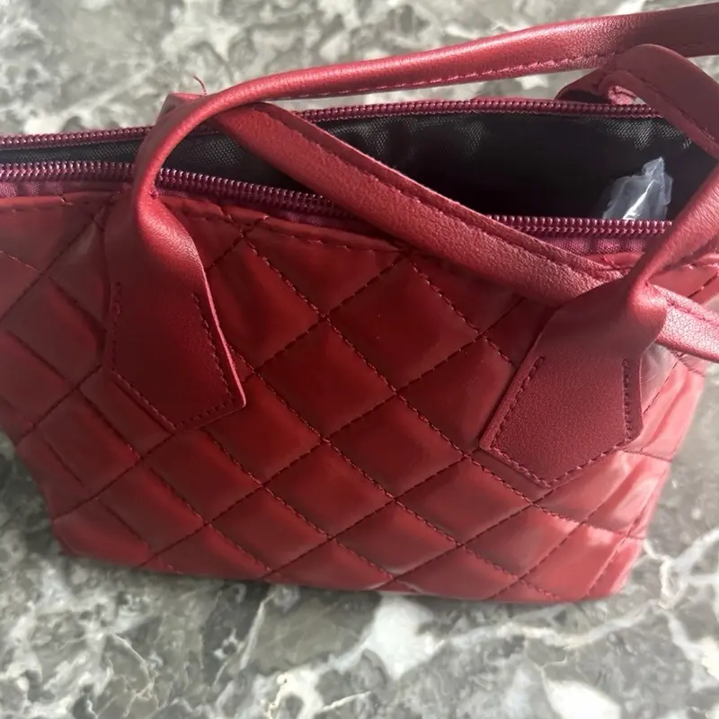 Red Quilted Handbag with Zipper Closure and Handle Design