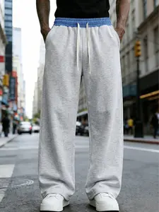 Loose and fashionable sports pants for men, featuring an outward-turned waistband and a color-block design. The wide-leg trousers are casual and simple, featuring a tie at the waist and large pockets, suitable for daily walks, work, travel, etc.