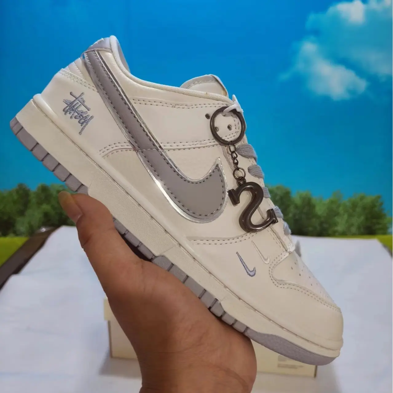 Streetwear casual kicks that instantly elevate every clean muted creamy neutral daily outfit, sweat-wicking perforated smooth leather upper adopting solid off-white base with shiny light gray reflective trim and unique embroidered text details