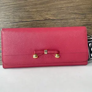 Pre-owned PRADA Saffiano leather Mini Bags pink continental wallet with bow and heart shaped gold tone detail...qg2670