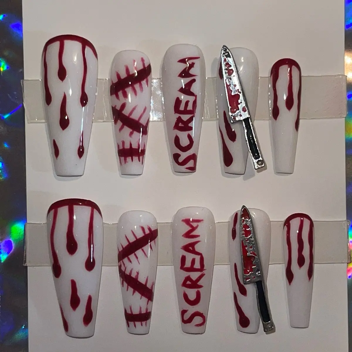 Halloween press on nails with blood and bloody rhinestone knife.