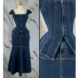 Structured corset-style top with front zipper closure  Contouring seam details for a sculpted fit  Matching high-waisted mermaid skirt  Flared hem for a dramatic silhouette  Premium denim fabric with slight stretch  Two-piece set for versatile styling