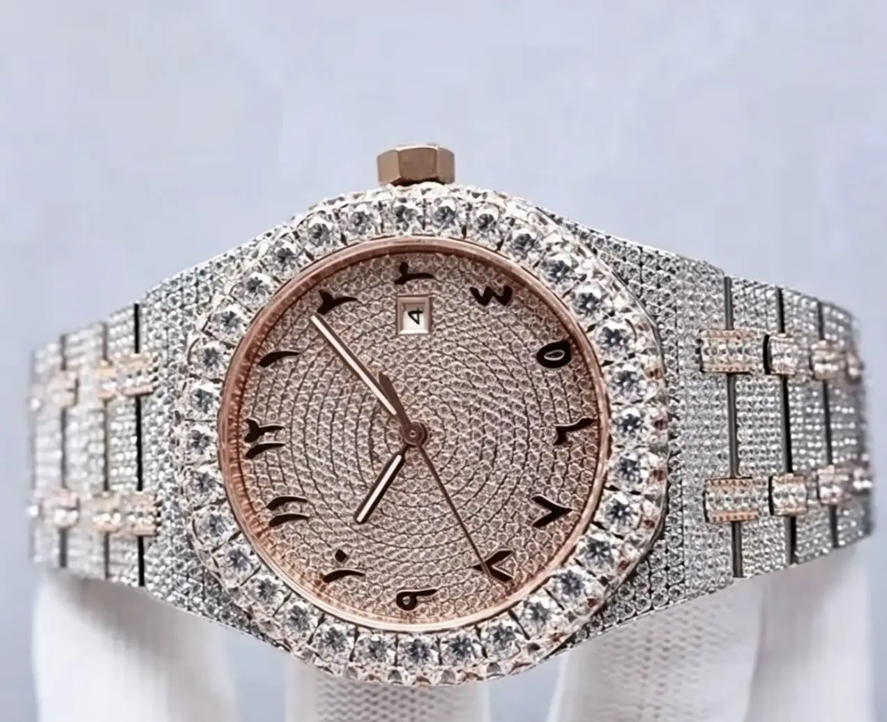 A rose gold and silver interwoven diamond watch, with a rose gold dial featuring Arabic numerals, 40mm in size, and a diamond-studded elegant wristwatch.