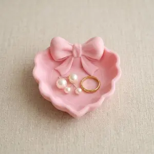 A Heart-Shaped Jewelry Tray with a Pink Bow, Made Using 3D Printing Technology, Suitable for Placement on a Dressing Table, Sink, Or for Storing Jewelry. It Is a Choice Home Decoration, Office Desks, And Jewelry Trays