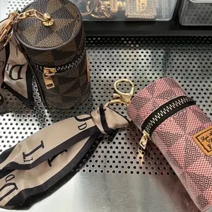 Stylish Bucket Keychain in Pink and Beige with Gold Accents and Zipper Detailing