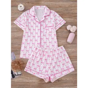 Two piece women's pajama set, pink bow theme, knitted fabric, comfortable to wear all year round, short sleeved button up top, matching shorts, collar and pocket details, suitable for women's adult sleepwear set