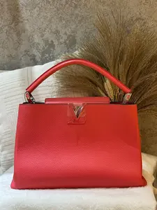 Pre-owned Louis Vuitton Capucines MM (Large) Handbag, crafted in 2015. Features the iconic embossed LV twist lock 1919H0643