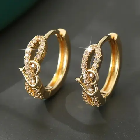 A pair of heart-shaped earrings made of synthetic white crystal, with a stylish, retro gold finish. High Quality Valentine Earrings Perfect for wearing on special occasions like weddings or holidays. Stud Earrings Jewelry