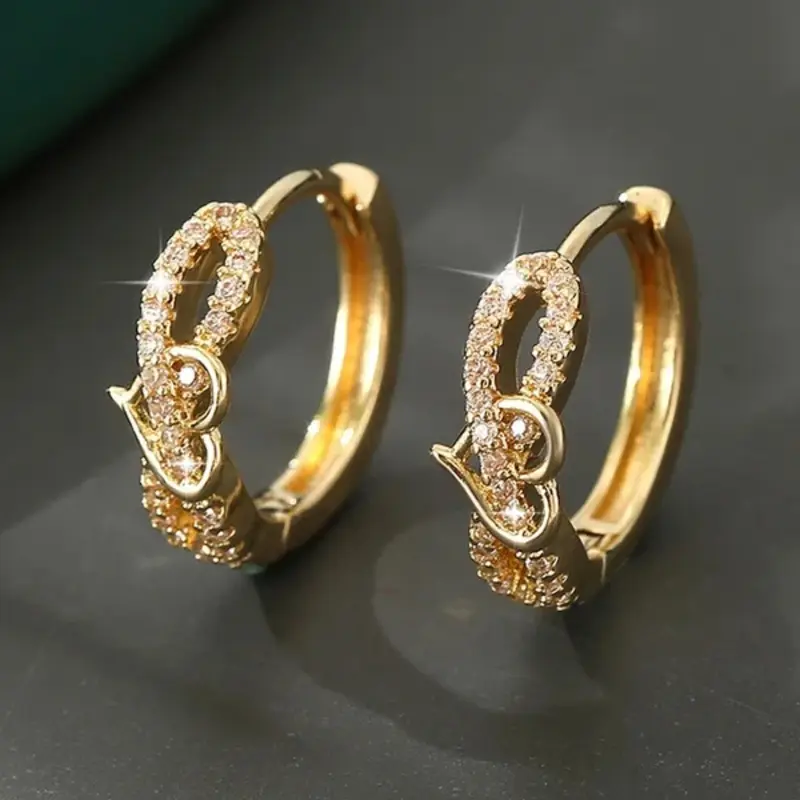 A pair of heart-shaped earrings made of synthetic white crystal, with a stylish, retro gold finish. High Quality Valentine Earrings Perfect for wearing on special occasions like weddings or holidays. Stud Earrings Jewelry