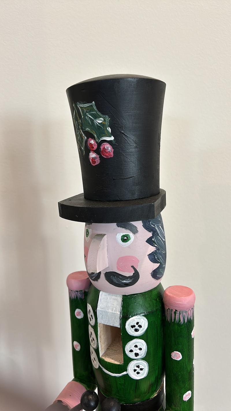 Hand-painted wooden nutcracker. He measures 24 inches tall. “Gunner” is a handsome guy that absolutely can live in your space year round.