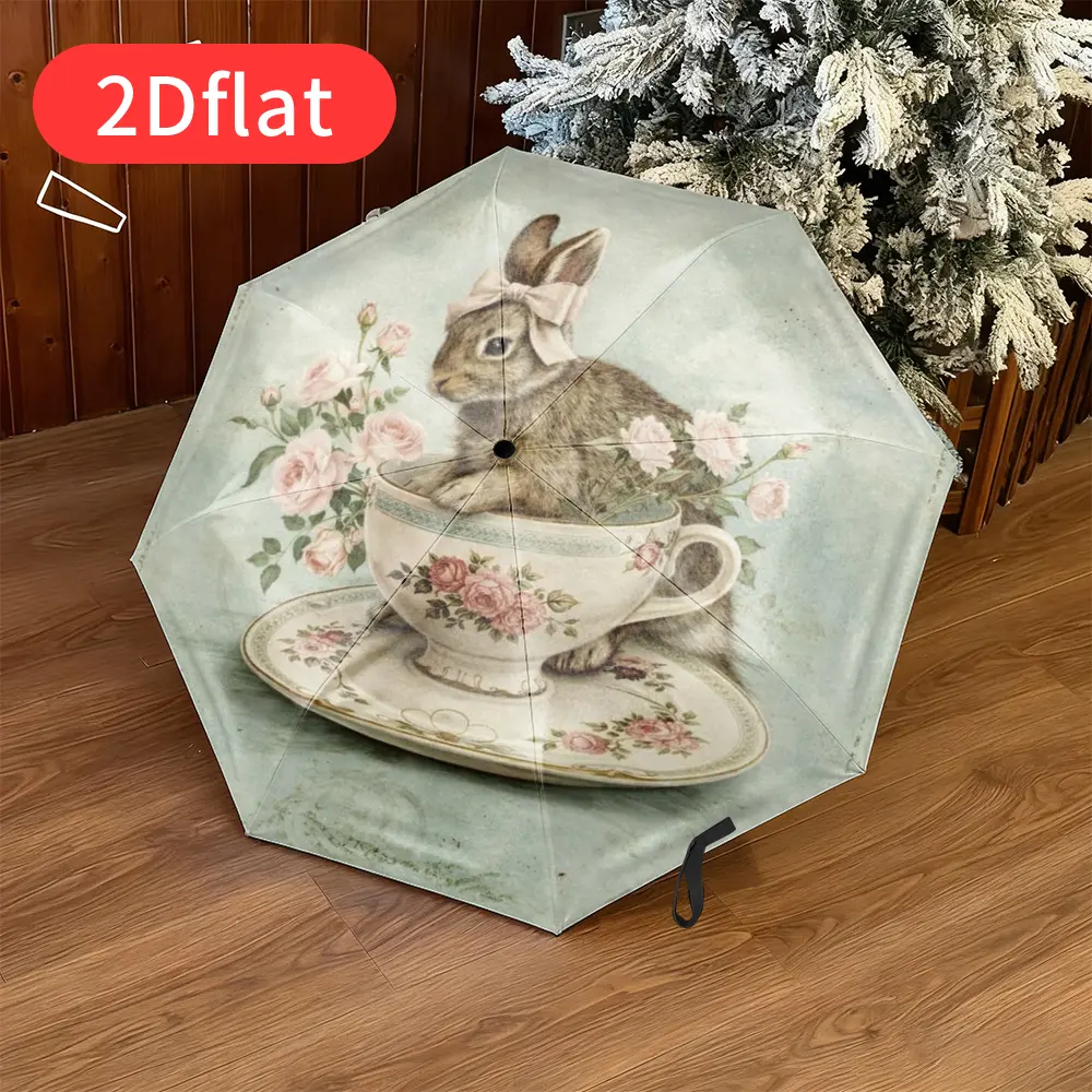 An Easter Bunny folding umbrella – featuring an adorable bunny sitting in a floral cup adorned with blooming roses, designed with a 2D flat print, lightweight and portable, perfect for everyday use, and made with