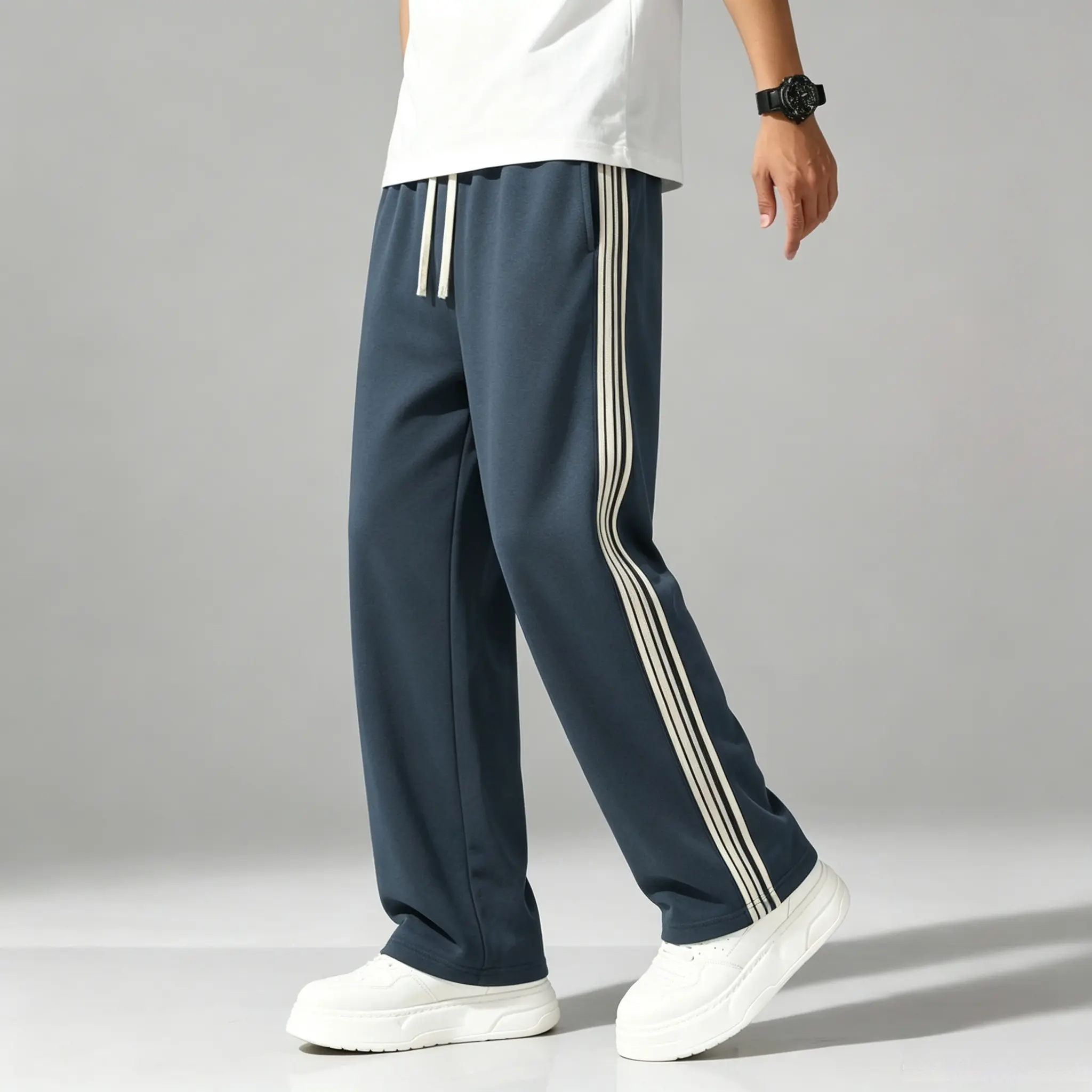 New autumn/winter loose athletic sweatpants featuring a classic side stripe design with drawstring fastening. Soft, high-stretch fabric that is comfortable and breathable. Straight-leg, wide-cut fit that helps conceal bulges and looks slimming. Suitable f