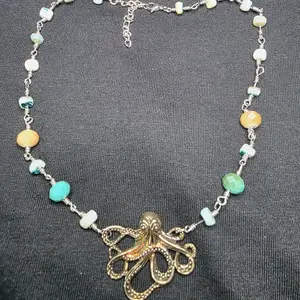 Wire wrapped shell chip and glass bead octopus necklace, handmade.
