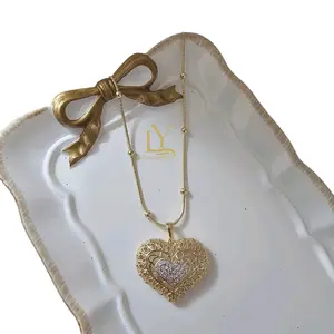 Cadena de Balines Corazón 14k Gold Heart Pendant with Bow and Chain.