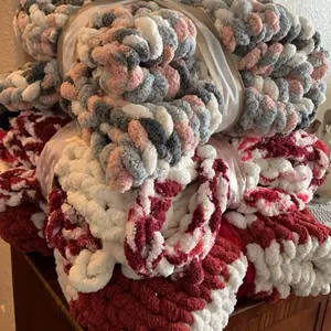 Hand knit chunky blankets made with 100% polyester yarn.