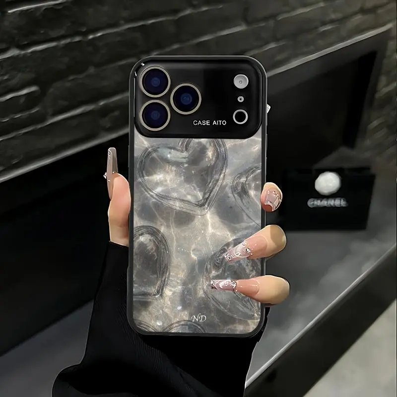 Water ripple textured transparent heart print phone case. Compatible with iPhone 17 Pro Max, 16 Pro Max, 15 Pro Max, and 14 Pro Max. Includes lens protection. Also compatible with iPhone 15, 14, 13, and 12. Made of skin-friendly TPU material.