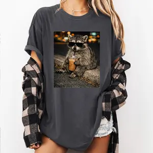 Funny Raccoon Drinking Iced Coffee Shirt: Animal Meme Graphic Tee