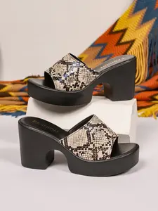 A pair of versatile snake-print platform heel sandals with slip-on design and stable heel. The bold patterns complement both casual and dressed-up looks, offering comfort and style for everyday wear.