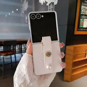 Embossed Silver Case with White Camellia Pattern and Matching Pearl Wrist Strap Samsung Phone Case for Galaxy Z Flip 7 FE / Z Flip 7 / Z Flip 6 / Z Flip 5