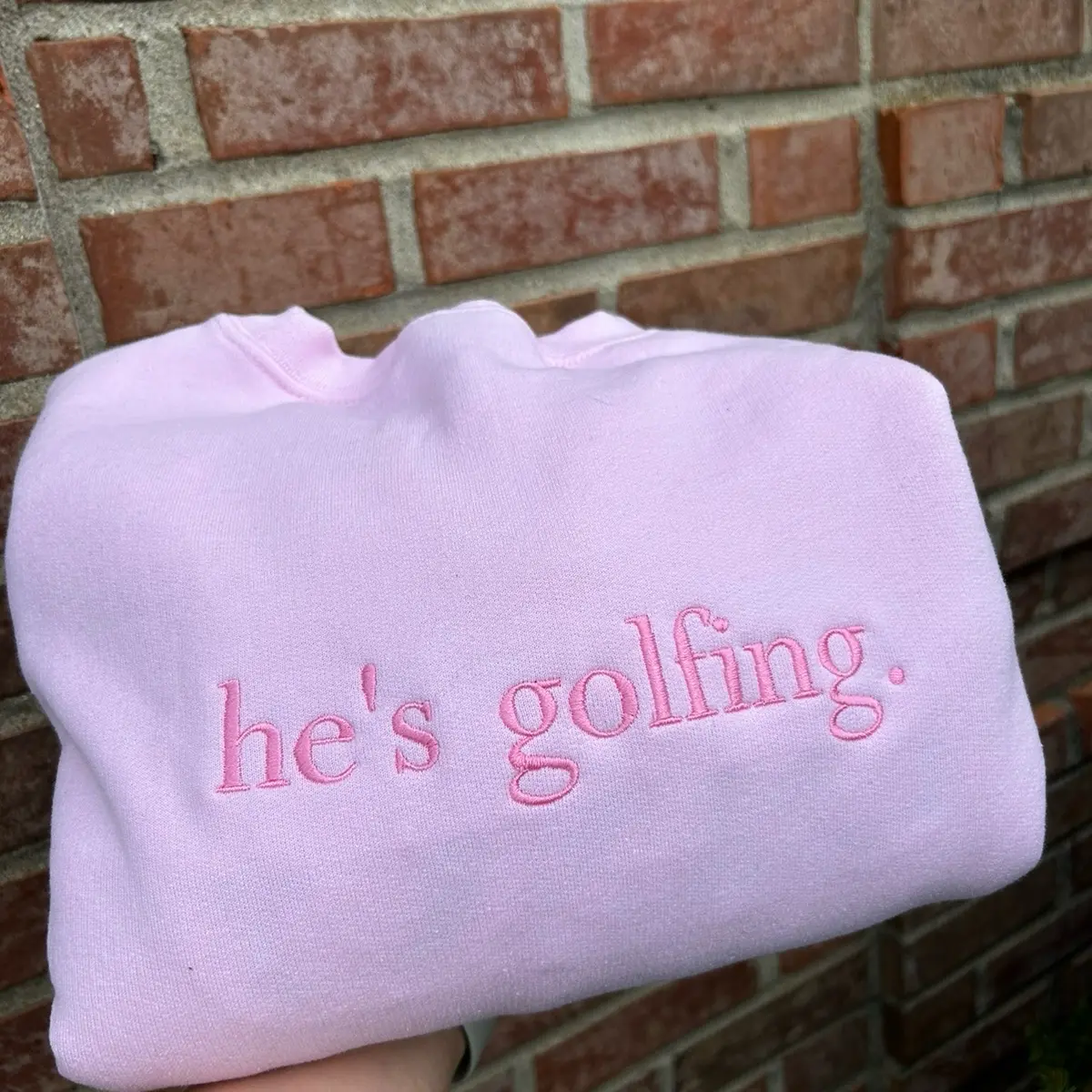Embroidered "he's golfing” hunting fishing working trendy and minimalist monochromatic crewneck neutral